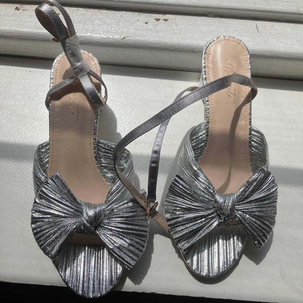 Metallic silver dressy sandals with bow detail and ankle strap